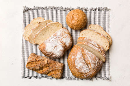 Freshly baked bread slices on napkin against natural background. top view Sliced bread.