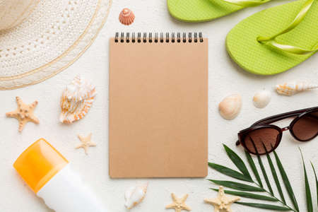 Blank writing book with summer beach accessories on background, copy space. Flat lay with copy space.の写真素材