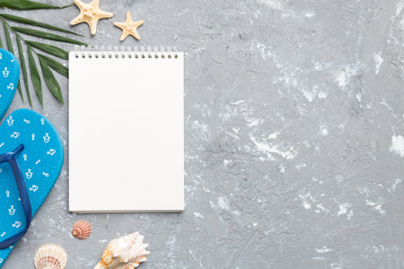 Blank writing book with summer beach accessories on background, copy space. Flat lay with copy space.の写真素材