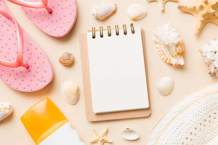 Blank writing book with summer beach accessories on background, copy space. Flat lay with copy...