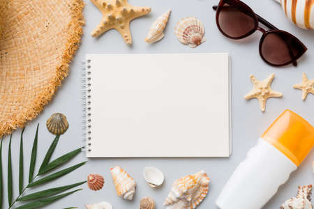 Blank writing book with summer beach accessories on background, copy space. Flat lay with copy space.の写真素材