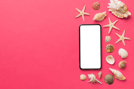 Flat lay composition with Phone and beach accessories on colored background. Smartphone with blank...
