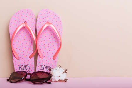beach accessories. Flip flops and starfish on colored background. Mock up with copyspace.の写真素材