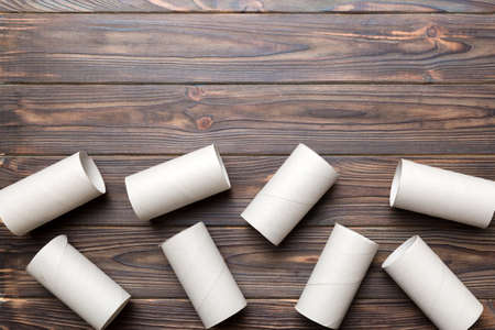 Flat lay composition with empty toilet paper rolls and space for text on color background. Recyclable paper tube with metal plug end made of kraft paper or cardboard.の写真素材
