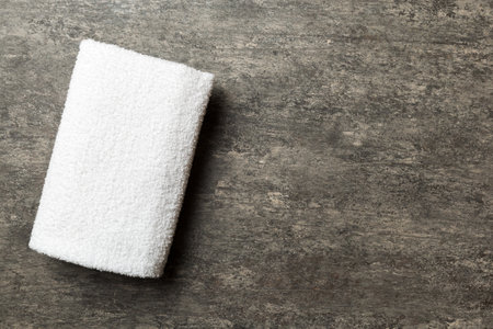 Top view of white towels with copy space on colored background.の写真素材