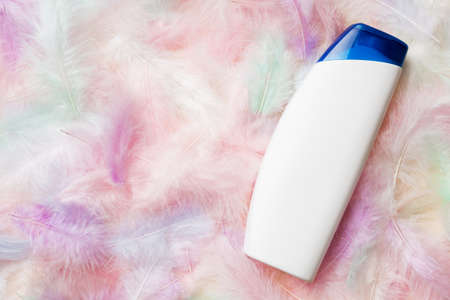 Spa cosmetic product, cream bottle, branding mock up, top view with feathers background. flat lay.の写真素材