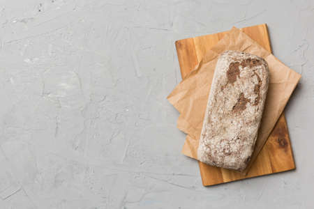 Freshly baked bread on cutting board against white wooden background. top view bread with copy...
