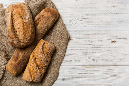 Assortment of freshly baked bread with napkin on rustic table top view. Healthy unleavened bread....