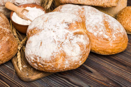 Homemade natural breads. Different kinds of fresh bread as background, perspective view with copy...