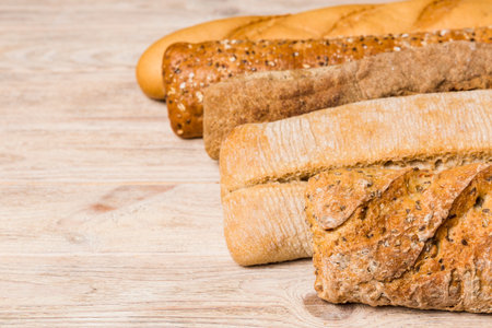 Homemade natural breads. Different kinds of fresh bread as background, perspective view with copy...
