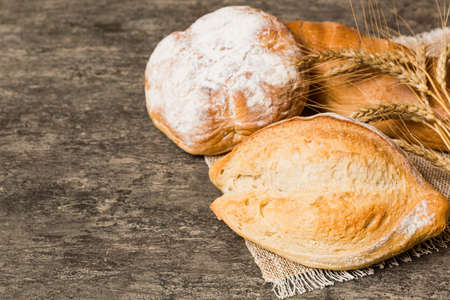 Homemade natural breads. Different kinds of fresh bread as background, perspective view with copy space.の写真素材