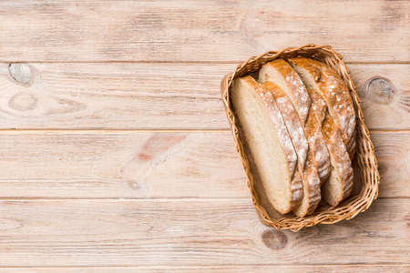 Freshly baked bread slices on basket against natural background. top view Sliced bread.