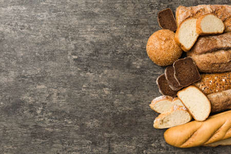 Homemade natural breads. Different kinds of fresh bread as background, top view with copy space.