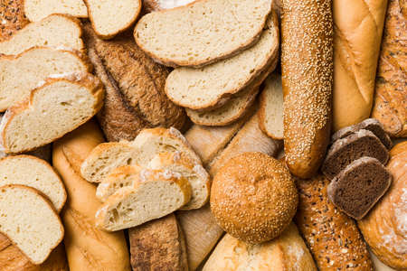 Homemade natural breads. Different kinds of fresh bread as background, top view with copy space.