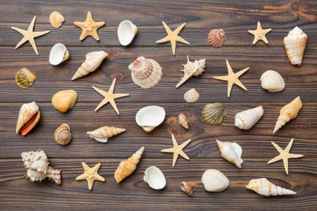 Summer time concept Flat lay composition with beautiful starfish and sea shells on colored table,...