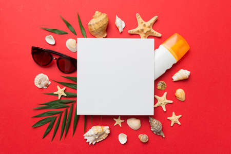 Summer time concept with blank greeting card and blank white paper on colored background. Seashells...
