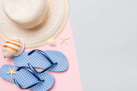 Summer vacation concept flat lay. straw hat beach accessories and flip flop top view. Space for...