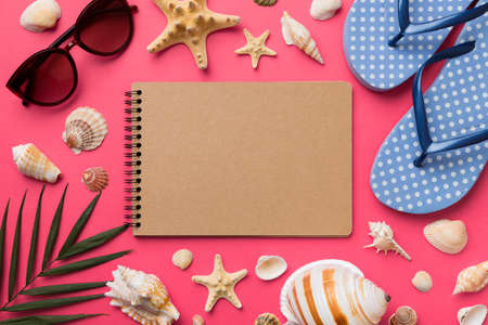 Blank writing book with summer beach accessories on background, copy space. Flat lay with copy space.の写真素材