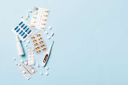 Protective face masks or surgical masks, medicine pills and thermometer on table background. coronavirus disease. Corona virus concept. Space for text.の写真素材