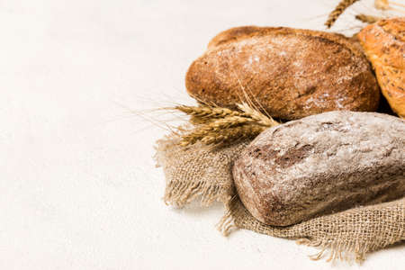 Homemade natural breads. Different kinds of fresh bread as background, perspective view with copy space.の写真素材