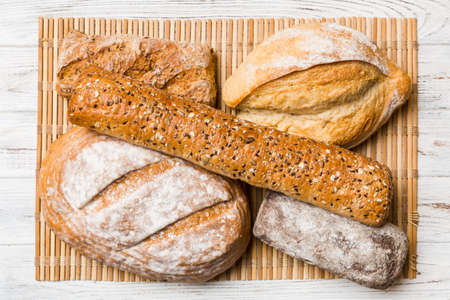 Assortment of freshly baked bread with napkin on rustic table top view. Healthy unleavened bread....