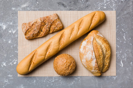 Assortment of freshly baked bread with napkin on rustic table top view. Healthy unleavened bread....