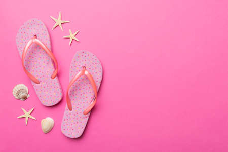 Flat lay composition with flip flops and seashell on colored background. Space for text view.の写真素材