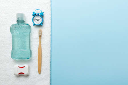 Mouthwash and other oral hygiene products on colored table top view with copy space. flat lay....