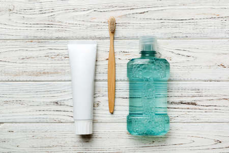 Mouthwash and other oral hygiene products on colored table top view with copy space. flat lay....
