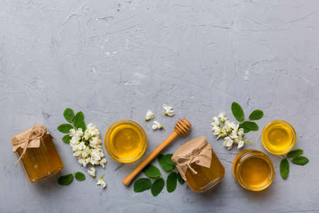honey jar with acacia flowers and leaves. fresh honey top view flat lay.の写真素材