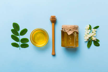 honey jar with acacia flowers and leaves. fresh honey top view flat lay.の写真素材