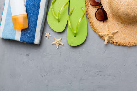 Summer vacation concept flat lay. straw hat beach accessories and towel top view. Space for text....