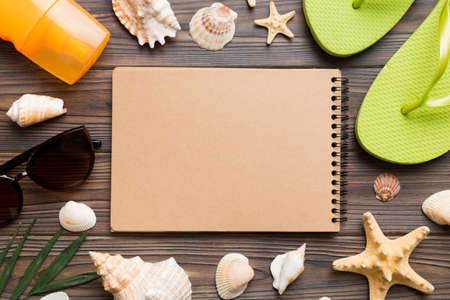 Blank writing book with summer beach accessories on background, copy space. Flat lay with copy space.の写真素材