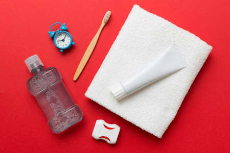 Mouthwash and other oral hygiene products on colored table top view with copy space. flat lay. dental hygiene. Oral care products and space for text on light background. concept.の写真素材