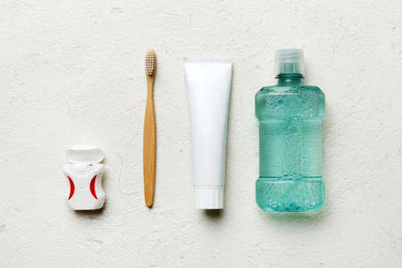 Mouthwash and other oral hygiene products on colored table top view with copy space. flat lay. dental hygiene. Oral care products and space for text on light background. concept.の写真素材