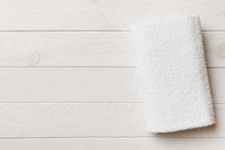 Top view of white towels with copy space on colored background.の写真素材
