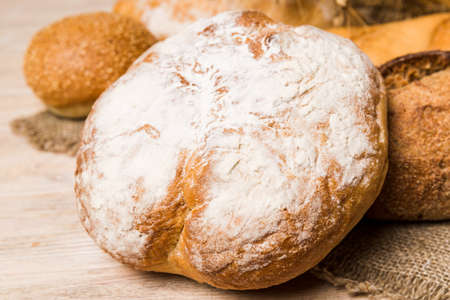 Homemade natural breads. Different kinds of fresh bread as background, perspective view with copy...