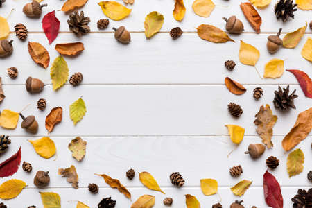 Autumn composition made of dried leaves, cones and acorns on table. Flat lay, top view, copy space.