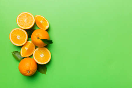 fresh Fruit orange slices on colored background. top view. copyspace. creative summer concept. Half...