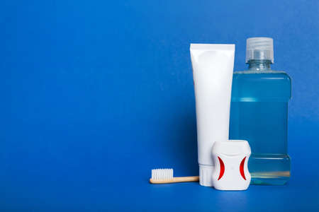 Mouthwash and other oral hygiene products on colored table top view with copy space. flat lay....