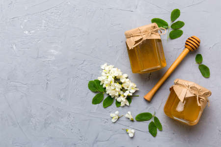 honey jar with acacia flowers and leaves. fresh honey top view flat lay.の写真素材
