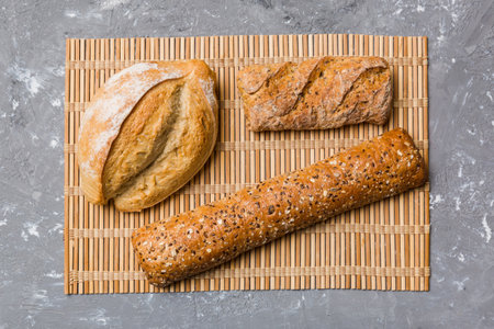 Assortment of freshly baked bread with napkin on rustic table top view. Healthy unleavened bread....
