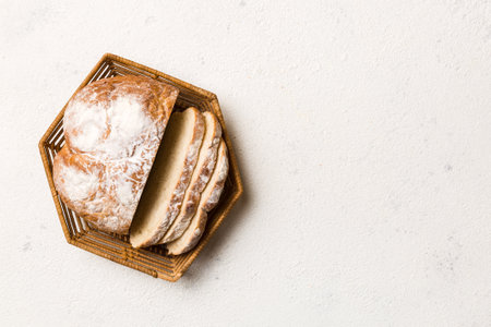 Freshly baked bread slices on basket against natural background. top view Sliced bread.