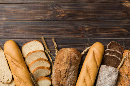 Homemade natural breads. Different kinds of fresh bread as background, top view with copy space.