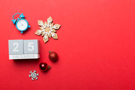 Christmas wood calendar with new year decorations, aganist colored background. Christmas calendar 25 December.の写真素材