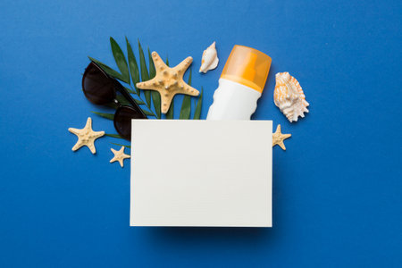 Summer time concept with blank greeting card and blank white paper on colored background. Seashells...