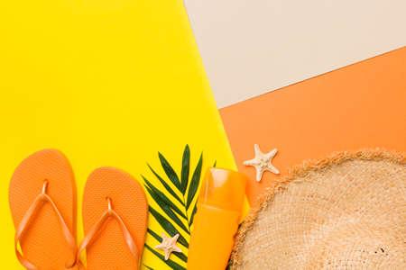 Summer vacation concept flat lay. straw hat beach accessories and flip flop top view. Space for...
