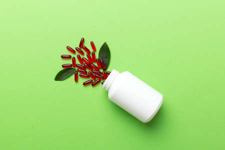 different drugs and health supplement pills poured from a medicine bottle health care and medical...
