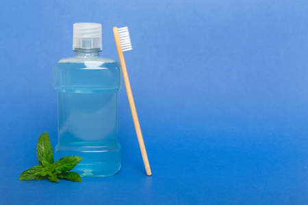 Mouthwash and fresh mint on colored background, top view with copy space for text.の写真素材