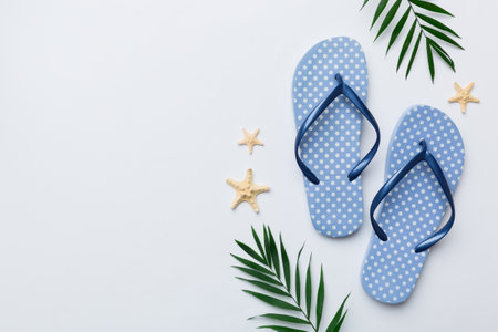 Flat lay composition with flip flops and seashell on colored background. Space for text view.の写真素材